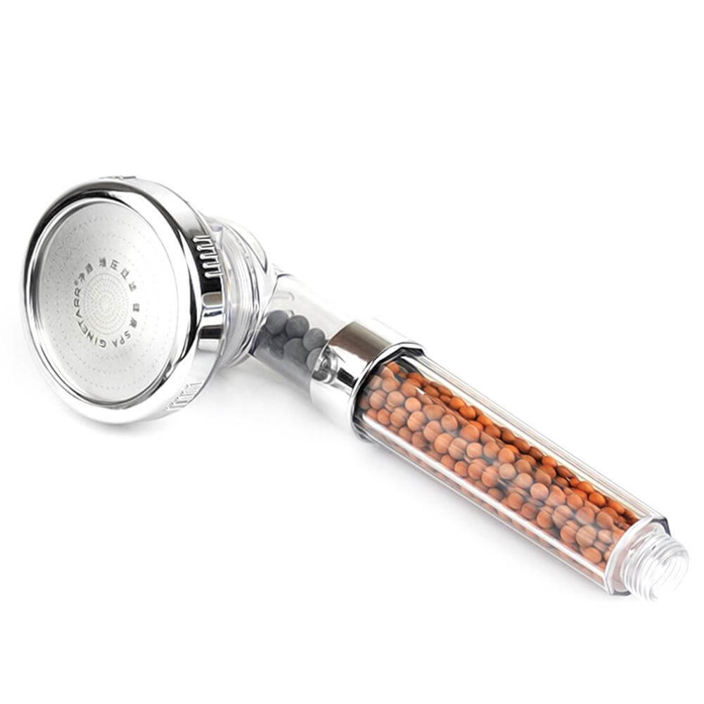 Shower head with decorative beads on a white background
