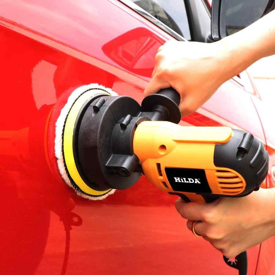 Electric car buffer with replaceable polishing pad on white background