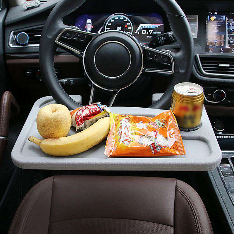 Compact car tray table on steering wheel for eating and writing